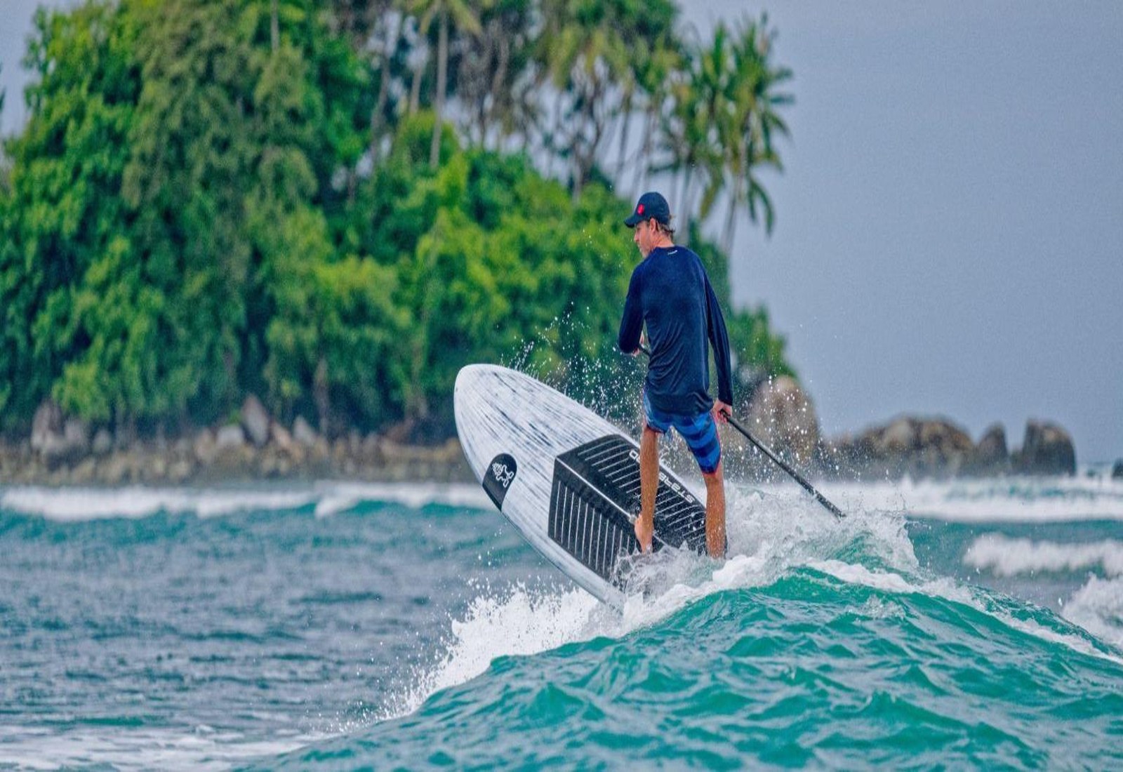 Starboard SUP racer driving a hardboard through open water